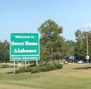 A "sweet home.." welcome sign greets everyone entering the state. 